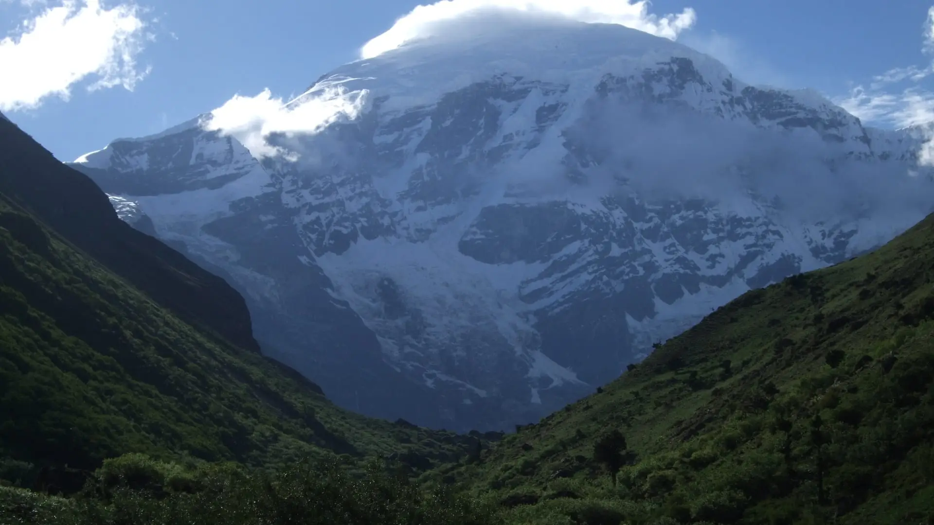 Mount Jomolhari wreathed in cloud above the green upper Paro Chhu valley