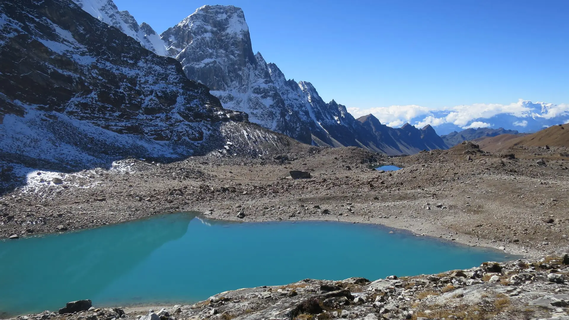 A turquoise glacial lake beneath the peaks on the high route