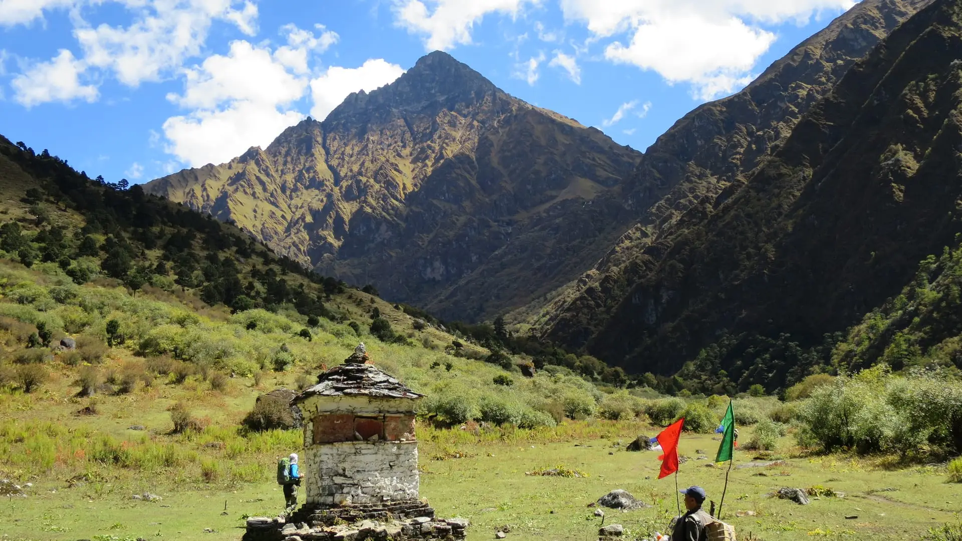 A trekker passes a chorten on the trail to Jangothang